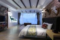 a bedroom with a bed and a brick wall at Follow Me designed B&amp;B in Dongshan
