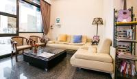 a living room with a couch and a coffee table at Kenting Mulan Homestay in Hengchun South Gate