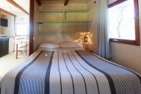 a large bed in a room with a window at Bungalows Tangana in Tarifa