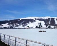 a body of water with a snow covered mountain at Maison de 2 chambres avec jardin clos et wifi a Marcillac la Croisille in Marcillac-la-Croisille