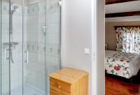 a bathroom with a glass shower and a bed at Maison de 2 chambres avec piscine privee jardin amenage et wifi a Bruniquel in Bruniquel
