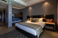 A bed or beds in a room at Sunrise Diamond Beach Resort -Grand Select