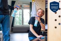 a woman is holding a bottle of water at Stayokay Hostel Amsterdam Vondelpark in Amsterdam