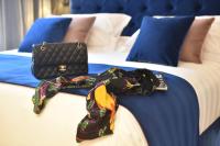 A bed or beds in a room at Duomo Hotel & Apartments