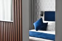 A bed or beds in a room at Duomo Hotel & Apartments