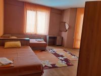 A bed or beds in a room at Gelov Hotel