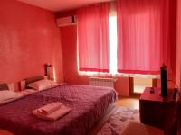 A bed or beds in a room at Gelov Hotel