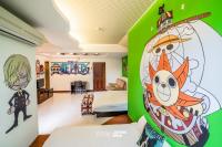 a room with a green wall with a cartoon on it at Ribbed Birch B&amp;B in Hualien City