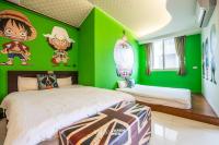 a bedroom with green walls and two beds at Ribbed Birch B&amp;B in Hualien City