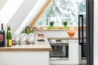 Kuchyňa alebo kuchynka v ubytovaní TatryTop Apartamenty Alpejski SPA