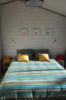 a large bed with two pillows in a bedroom at Chalet la lande in Ondres