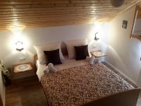 a bedroom with a large bed with two lamps at Lake House 1 in Plitvička Jezera