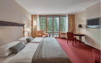 Posteľ alebo postele v izbe v ubytovaní Lebenberg Schlosshotel-Kitzbühel