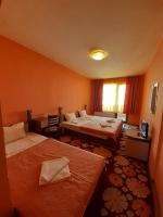 A bed or beds in a room at Gelov Hotel