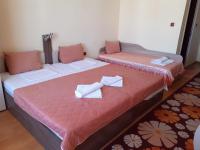 A bed or beds in a room at Gelov Hotel