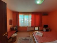 A bed or beds in a room at Gelov Hotel