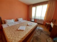 A bed or beds in a room at Gelov Hotel