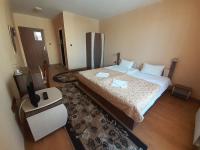 A bed or beds in a room at Gelov Hotel