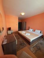 A bed or beds in a room at Gelov Hotel