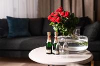 a table with two bottles of champagne and a vase with roses at Hotel Sparre in Porvoo