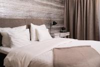 a bedroom with a bed with white sheets and pillows at Hotel Sparre in Porvoo