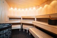 a sauna with wooden benches and shelves in a room at Hotel Sparre in Porvoo