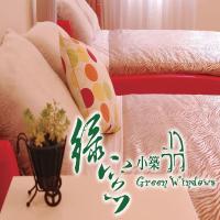 a room with a bed with a table with a table sidx sidx at Green Window Homestay in Hualien City