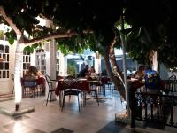 een groep mensen die aan tafels in een restaurant zitten bij Metaxa Apartments in Kavos