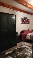 a bedroom with a bed and a black closet at Horizon Aubrac Laguiole in Laguiole