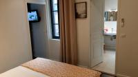 a bedroom with a bed and a bathroom with a window at Burdigala Homes - Les Apparts de la Course in Bordeaux