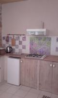 a kitchen with a stove and a white refrigerator at Le roc de l&#39;aigle in Cabrespine