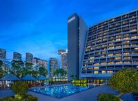 a building with a pool in front of a city at PARKROYAL COLLECTION Marina Bay, Singapore in Singapore