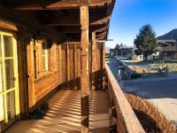 a wooden porch of a building on a street at Alpin Residenzen Panoramabahn by Alpina-Holiday in Hollersbach im Pinzgau
