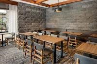 a restaurant with wooden tables and chairs at Hyatt Place Pittsburgh North Shore in Pittsburgh