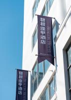 two flags hanging from the side of a building at Beacon Hotel in Taichung