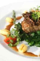 um prato branco de alimentos com carne e produtos hortícolas em Müller´s Landhotel em Mespelbrunn