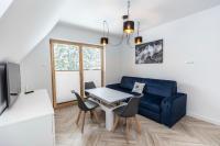 Televízia a/alebo spoločenská miestnosť v ubytovaní TatryTop Apartamenty Alpejski SPA