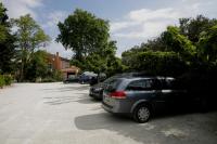 a row of cars parked in a parking lot at Logis Hotel Restaurant la Ferme in Avignon