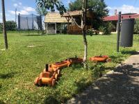 a group of orange flower pots in the grass at Salaš Gnijezdo in Bačka Palanka
