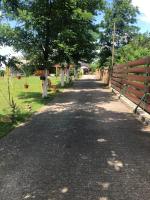 a road with a fence and trees in a field at Salaš Gnijezdo in Bačka Palanka