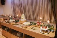 a table with a wedding cake and food on it at Royal Airport Hotel in Velika Gorica