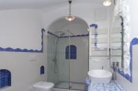 a bathroom with a shower and a toilet and a sink at Villa Ambra Positano in Positano