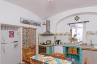 a kitchen with a table and a refrigerator at Villa Ambra Positano in Positano