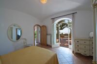 a bedroom with a bed and a dresser and a mirror at Villa Ambra Positano in Positano