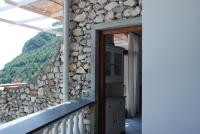 a stone wall in a house with a window at Villa Ambra Positano in Positano