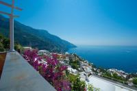 a view of the amalfi coast with purple flowers at Villa Ambra Positano in Positano