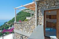 a stone house with a view of the ocean at Villa Ambra Positano in Positano