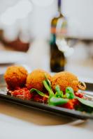 two fried chicken on a plate with sauce at Hotel O3zone in Băile Tuşnad