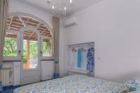 a bedroom with a bed and an open door at Villa Ambra Positano in Positano