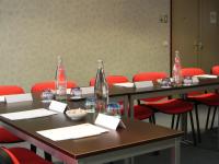 a conference room with tables and red chairs at Holiday Inn Paris Montmartre, an IHG Hotel in Paris